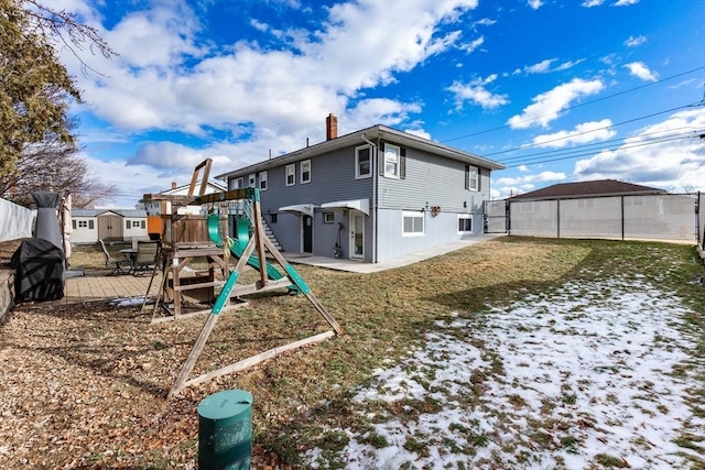 back of house with a playground, a patio area, and a lawn