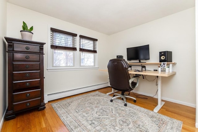 office space with a baseboard radiator and light hardwood / wood-style floors