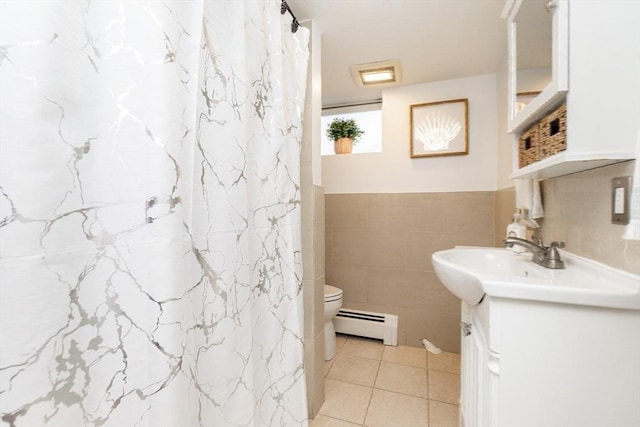 bathroom featuring tile patterned floors, toilet, tile walls, a baseboard radiator, and vanity