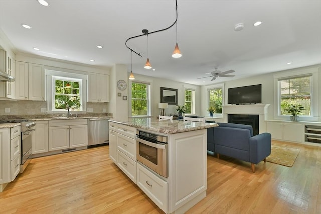 12 Coolidge Ave, Lexington, MA 02420 - kitchen with appliances with stainless steel finishes, plenty of natural light, light wood finished floors, a kitchen island, and recessed lighting