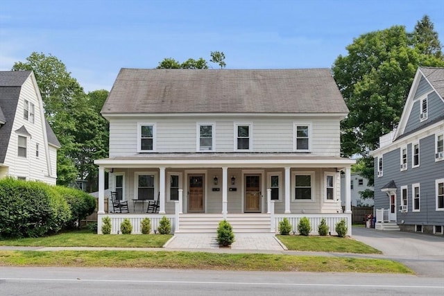 61 Elm St Unit 61, Andover, MA 01810 - view of front of home with covered porch, a front lawn, and roof with shingles