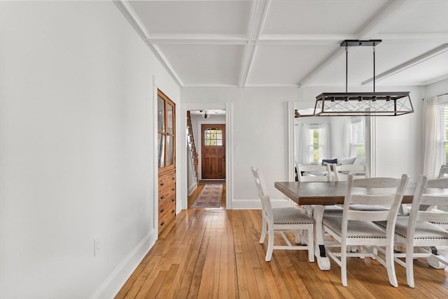 61 Elm St Unit 61, Andover, MA 01810 - dining space featuring coffered ceiling, healthy amount of natural light, light wood-type flooring, and beamed ceiling