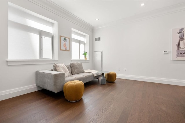 sitting room featuring ornamental molding, recessed lighting, baseboards, and wood finished floors