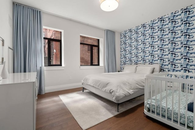 bedroom with baseboards and wood finished floors