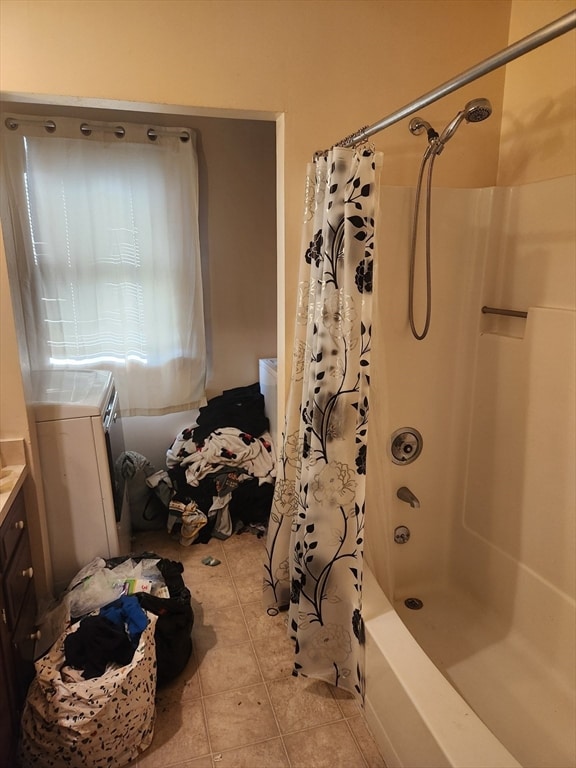 bathroom featuring vanity, washer / clothes dryer, shower / bath combo, and tile patterned flooring