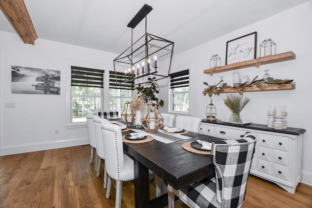 30 Indian Cove Rd, Marion, MA 02738 - dining area with a chandelier, wood finished floors, baseboards, and beam ceiling