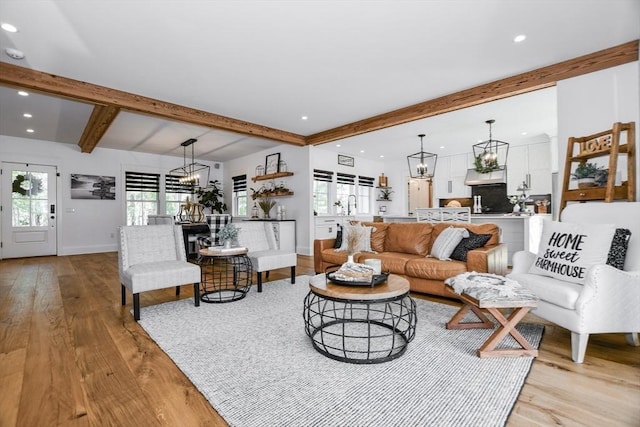 30 Indian Cove Rd, Marion, MA 02738 - living room with a chandelier, light wood finished floors, plenty of natural light, beam ceiling, and baseboards