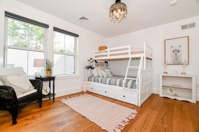 30 Indian Cove Rd, Marion, MA 02738 - bedroom with baseboards, multiple windows, wood finished floors, and a chandelier