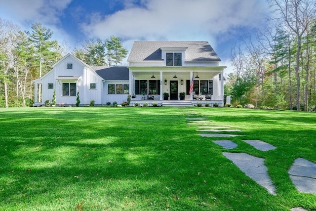 30 Indian Cove Rd, Marion, MA 02738 - view of front of house featuring board and batten siding, a front yard, a ceiling fan, and covered porch