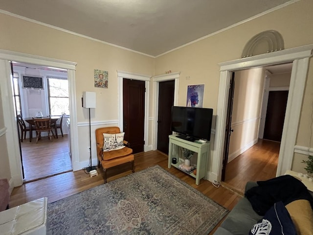 living room with ornamental molding and dark hardwood / wood-style floors