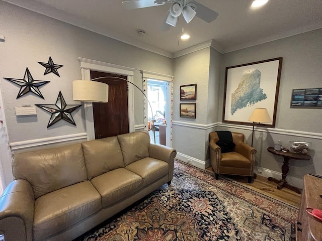 living room with crown molding, hardwood / wood-style floors, and ceiling fan