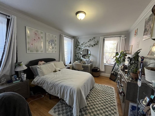 bedroom with ornamental molding and hardwood / wood-style floors