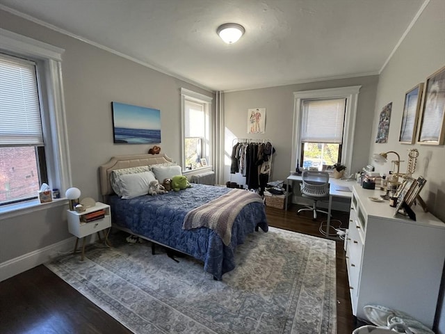 bedroom with ornamental molding and dark hardwood / wood-style floors