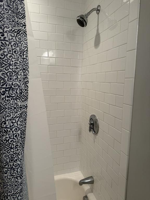 bathroom with shower / bathtub combination with curtain