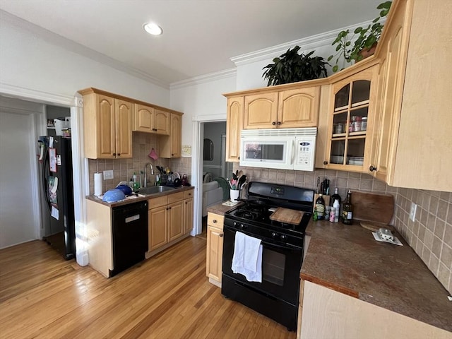 kitchen featuring sink, light brown cabinets, light wood-type flooring, and black appliances