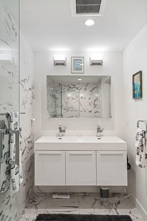 288 Marginal St Unit 4, Boston, MA 02128 - bathroom with a marble finish shower, double vanity, marble finish floors, baseboards, and recessed lighting