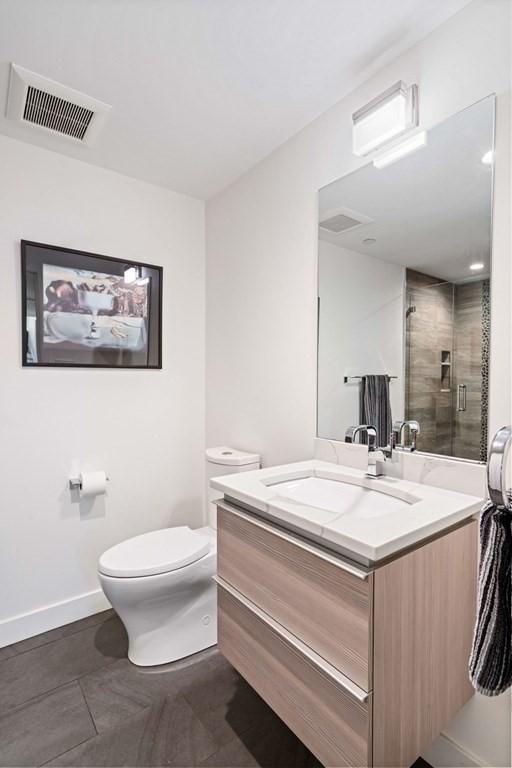 288 Marginal St Unit 4, Boston, MA 02128 - bathroom with vanity, baseboards, toilet, and a shower stall