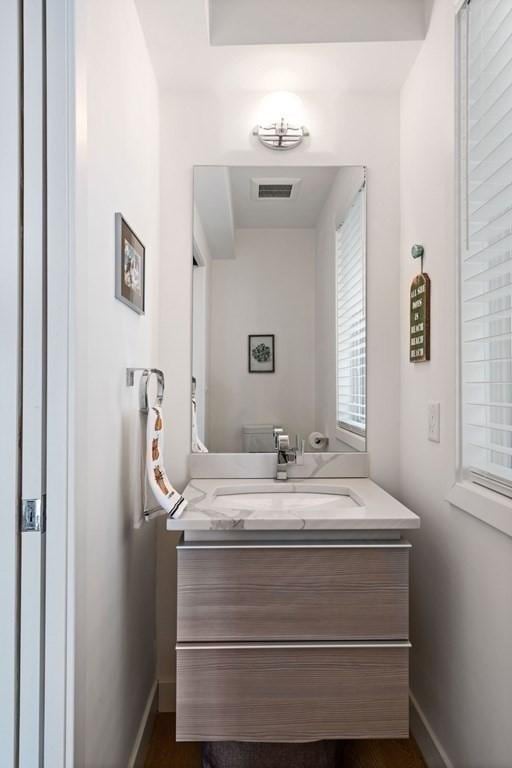 288 Marginal St Unit 4, Boston, MA 02128 - bathroom with vanity, baseboards, and healthy amount of natural light