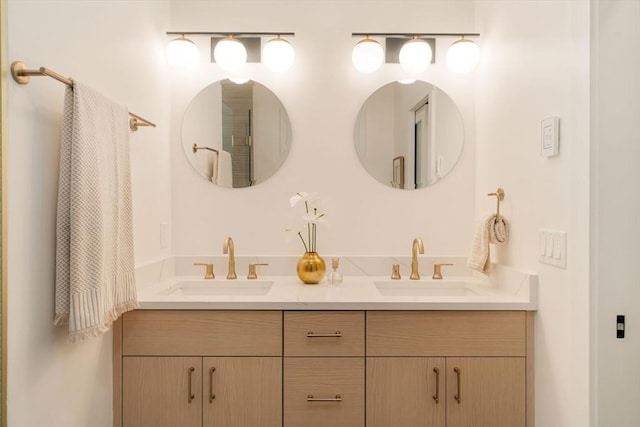 full bathroom with double vanity and a sink