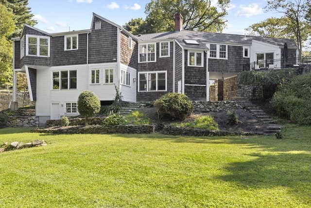 back of house with a lawn, a chimney, and stairs