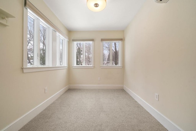 carpeted empty room with baseboards