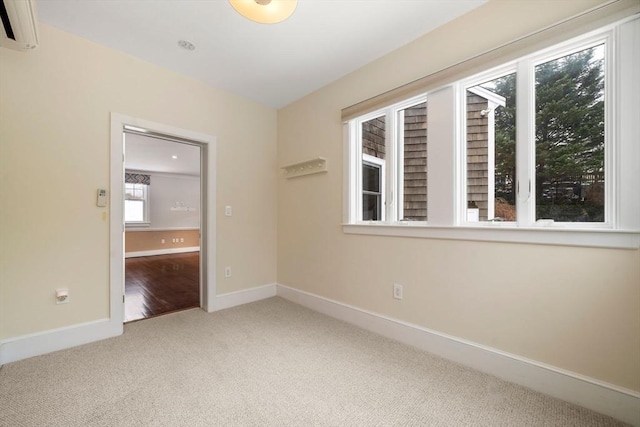 carpeted empty room with baseboards