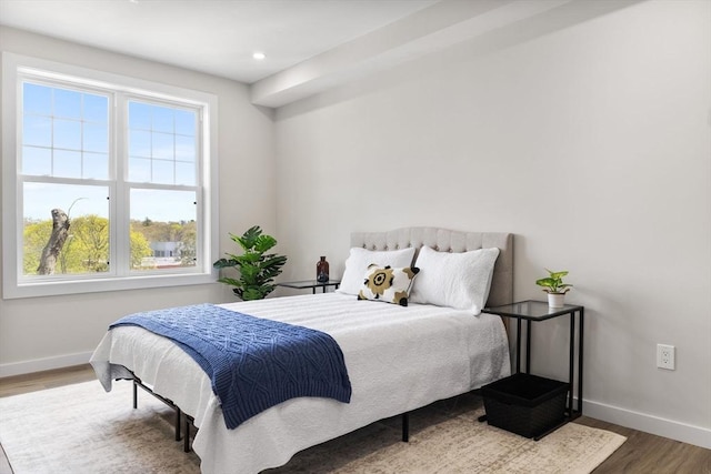 43-47 Fremont Unit 7, Boston, MA 02126 - bedroom featuring baseboards, multiple windows, and wood finished floors