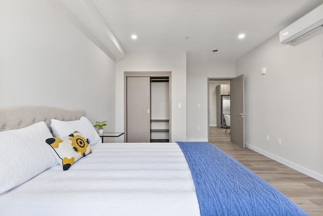 43-47 Fremont Unit 7, Boston, MA 02126 - bedroom featuring wood finished floors, recessed lighting, baseboards, and a wall unit AC