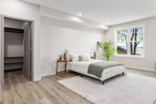 43-47 Fremont Unit 7, Boston, MA 02126 - bedroom with baseboards, recessed lighting, light wood-style flooring, and a walk in closet