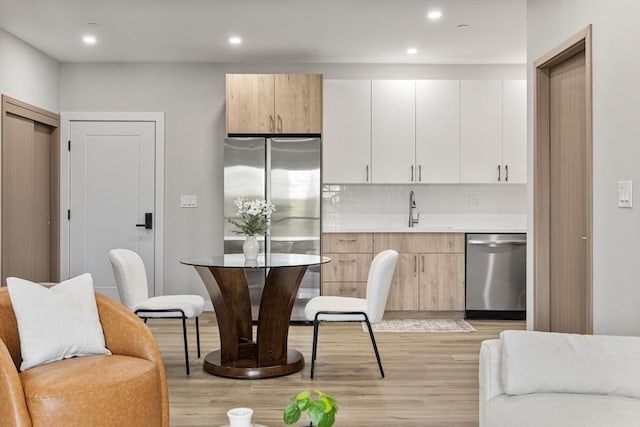 43-47 Fremont Unit 7, Boston, MA 02126 - kitchen featuring a sink, light wood-style floors, stainless steel appliances, recessed lighting, and tasteful backsplash