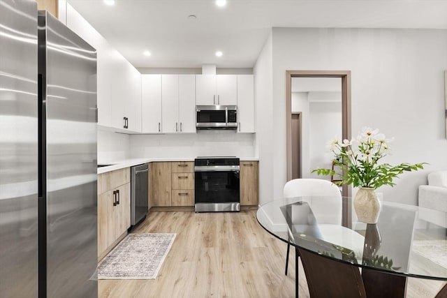 43-47 Fremont Unit 7, Boston, MA 02126 - kitchen featuring light wood finished floors, light countertops, stainless steel appliances, recessed lighting, and decorative backsplash
