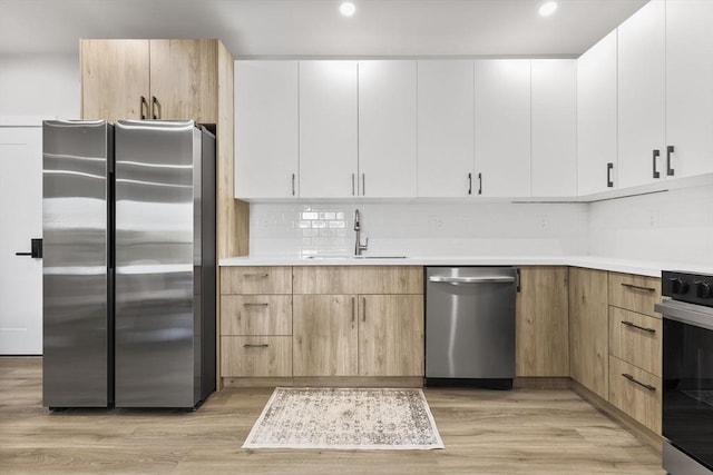 43-47 Fremont Unit 7, Boston, MA 02126 - kitchen featuring a sink, light countertops, stainless steel appliances, and light wood-style flooring