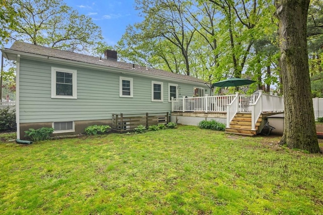 304 Hunting Rd, Needham, MA 02494 - rear view of house with a chimney, a wooden deck, and a lawn