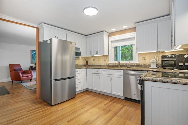 304 Hunting Rd, Needham, MA 02494 - kitchen with stainless steel appliances, a sink, light wood-type flooring, white cabinets, and recessed lighting