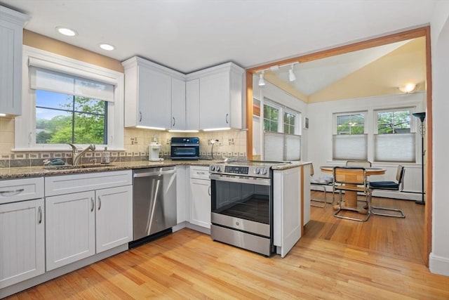 304 Hunting Rd, Needham, MA 02494 - kitchen with stainless steel appliances, a sink, light wood-style floors, plenty of natural light, and lofted ceiling