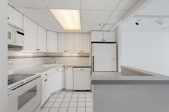 73 Broad Reach Unit T77C, Weymouth, MA 02191 - kitchen featuring white appliances, white cabinets, a paneled ceiling, and light tile patterned flooring