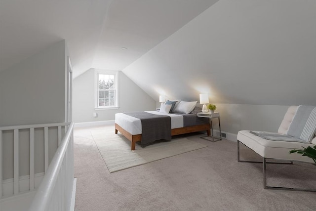 bedroom with light carpet and vaulted ceiling