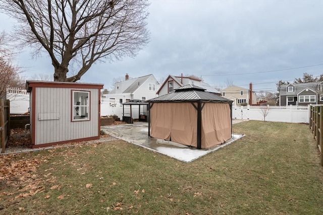 view of outdoor structure with a gazebo and a lawn