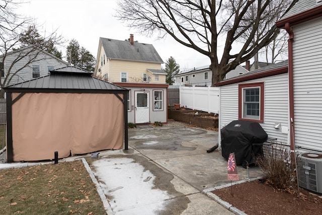 view of patio / terrace with a storage shed, central AC, and grilling area