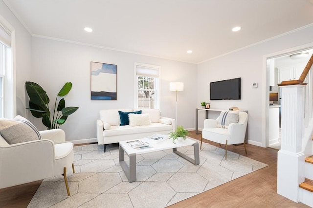 living room featuring crown molding and light wood-type flooring