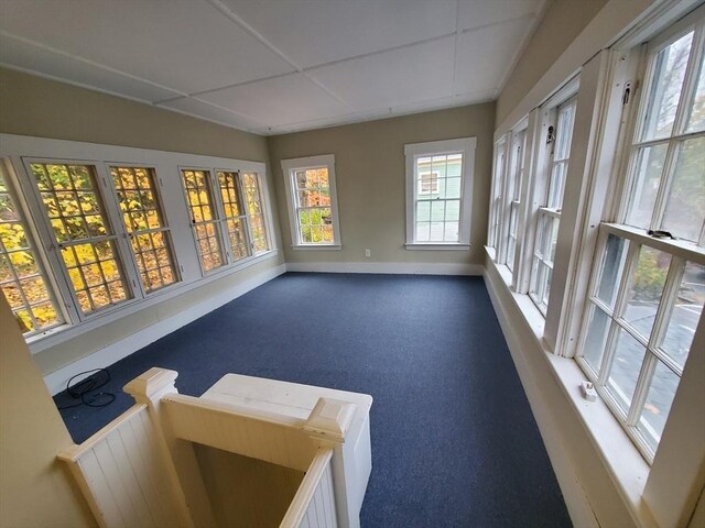 sunroom featuring a paneled ceiling