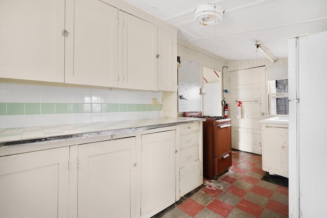 7 Crescent Pl, Wareham, MA 02558 - kitchen featuring white appliances, dark flooring, white cabinets, tile counters, and decorative backsplash