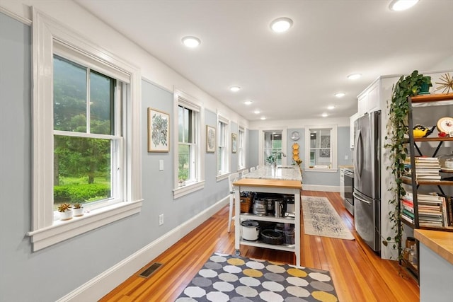 965 Greenville Ave, Smithfield, RI 02828 - kitchen featuring white cabinets, light wood-style floors, freestanding refrigerator, recessed lighting, and open shelves