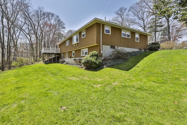 view of home's exterior with a lawn, a deck, and central AC