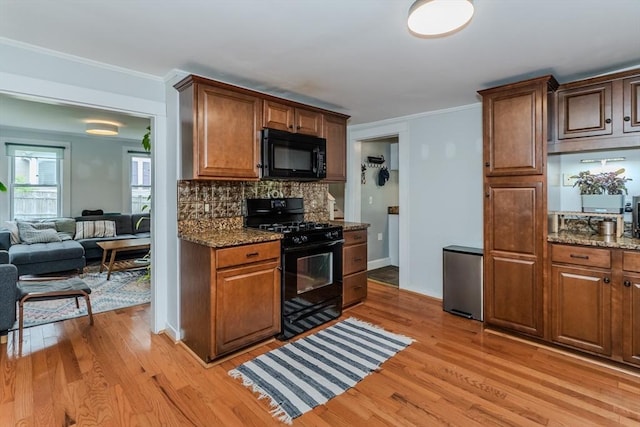 15 Ryan Rd, Northampton, MA 01062 - kitchen featuring black appliances, light wood-style flooring, backsplash, stone counters, and crown molding