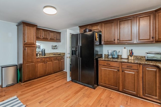15 Ryan Rd, Northampton, MA 01062 - kitchen with black refrigerator with ice dispenser, light wood-style floors, stone countertops, and crown molding