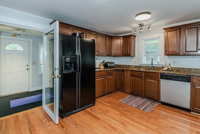 15 Ryan Rd, Northampton, MA 01062 - kitchen featuring stainless steel dishwasher, black fridge, a sink, light wood finished floors, and plenty of natural light