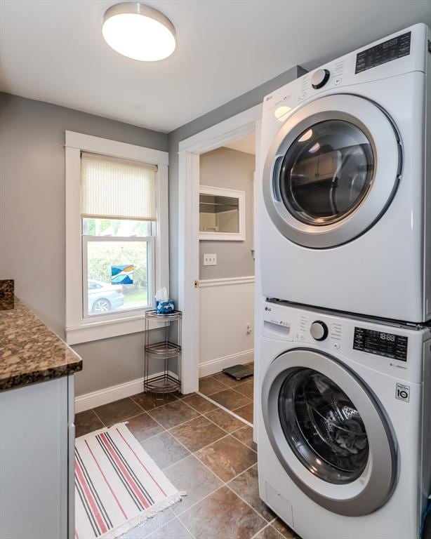 15 Ryan Rd, Northampton, MA 01062 - laundry room featuring stacked washer / drying machine, cabinet space, and baseboards