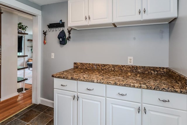 15 Ryan Rd, Northampton, MA 01062 - kitchen featuring white cabinetry, baseboards, and dark stone countertops