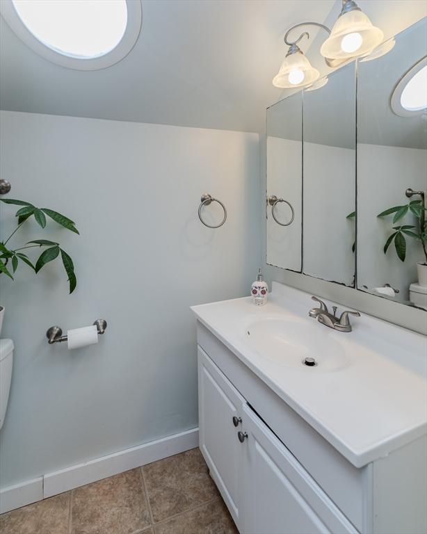 15 Ryan Rd, Northampton, MA 01062 - bathroom with toilet, vanity, baseboards, and tile patterned floors